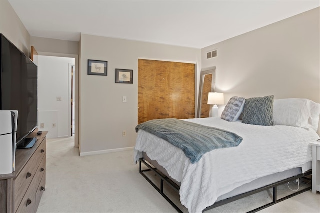 bedroom with light colored carpet, baseboards, and visible vents