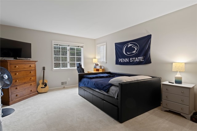 carpeted bedroom featuring baseboards and visible vents
