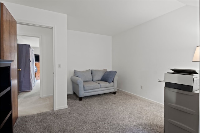 living area featuring carpet floors and baseboards