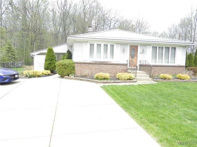 ranch-style home with brick siding, fence, a chimney, and a front yard