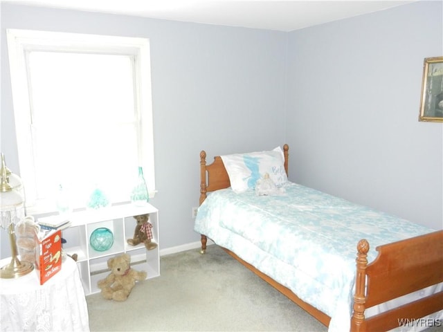 carpeted bedroom featuring baseboards