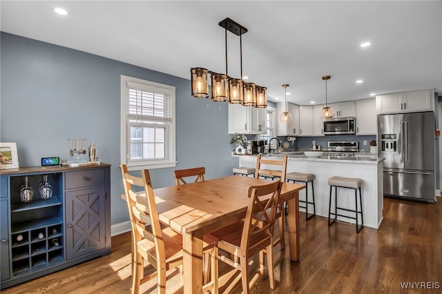 dining room featuring recessed lighting, dark wood finished floors, and baseboards