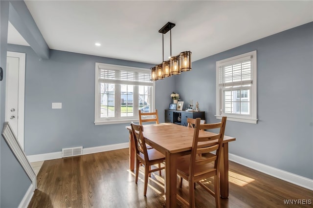 dining area featuring visible vents, wood finished floors, and a wealth of natural light