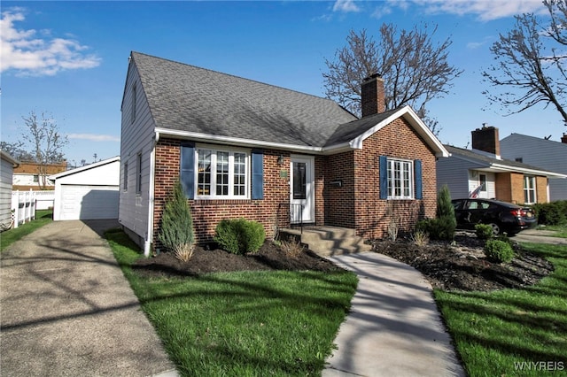 view of front facade with an outdoor structure, a chimney, brick siding, a shingled roof, and a detached garage