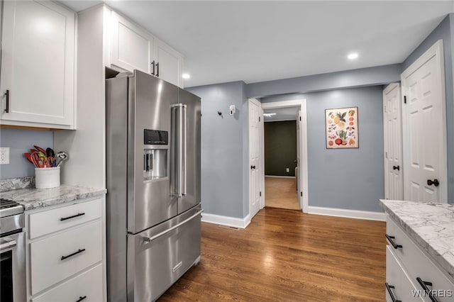 kitchen with baseboards, recessed lighting, white cabinets, dark wood finished floors, and stainless steel appliances