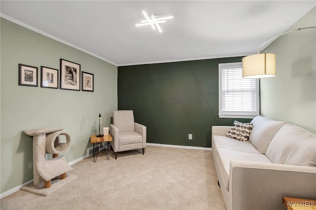 living room with crown molding, baseboards, a decorative wall, and light carpet