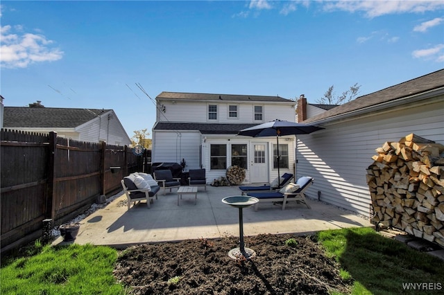 back of property with a fenced backyard, a patio, and outdoor lounge area