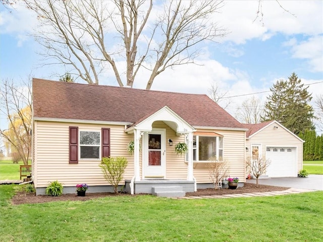view of front of house with a shingled roof, concrete driveway, and a front lawn