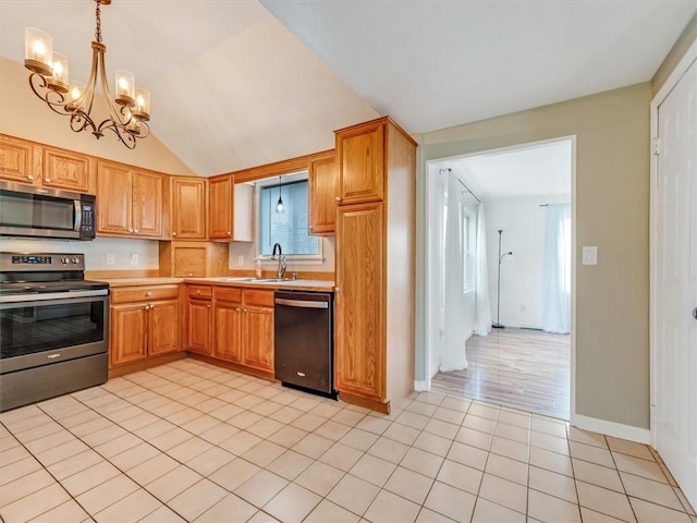 kitchen featuring light countertops, light tile patterned flooring, appliances with stainless steel finishes, and a sink