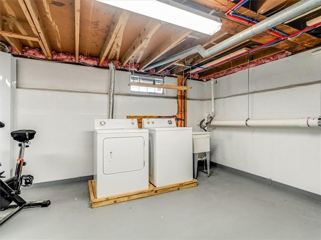 laundry area featuring washing machine and clothes dryer, laundry area, and baseboards
