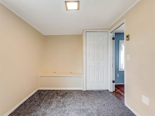 carpeted empty room with baseboards and ornamental molding