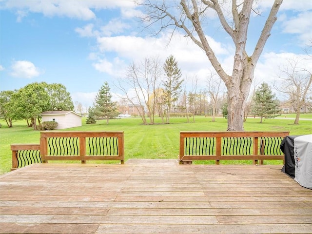 wooden terrace with a lawn