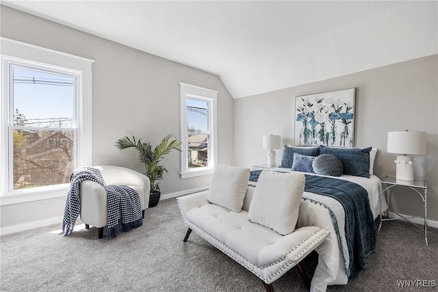 carpeted bedroom with baseboards and vaulted ceiling