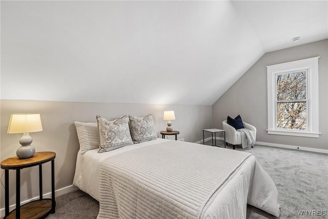 carpeted bedroom featuring baseboards and vaulted ceiling