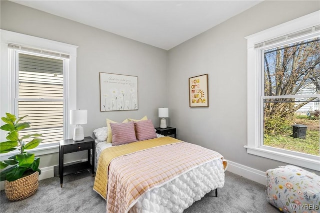 bedroom with baseboards and carpet