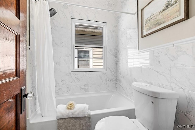 bathroom with tile walls, toilet, and shower / bath combination with curtain