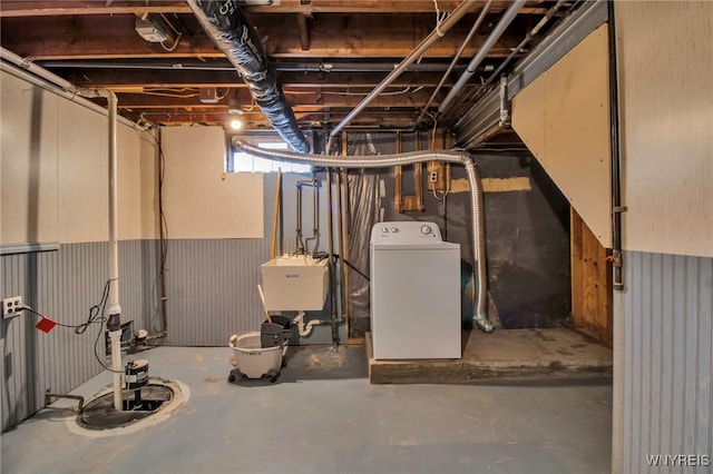 below grade area featuring washer / dryer and a sink