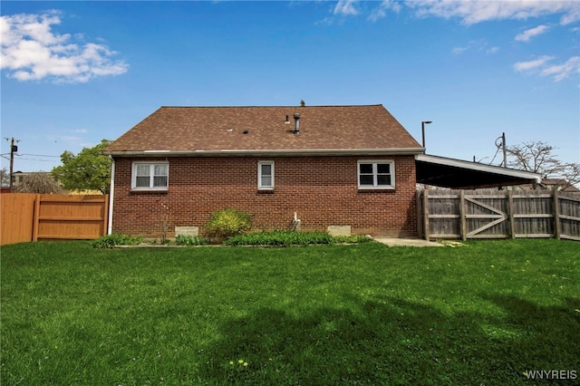 back of property featuring a fenced backyard and a yard