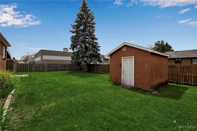 view of yard featuring a fenced backyard, an outdoor structure, and a storage shed