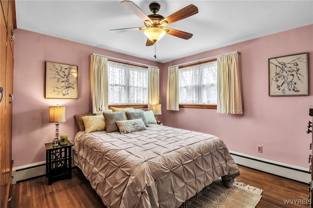 bedroom with a ceiling fan, a baseboard heating unit, and wood finished floors