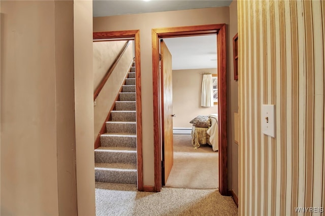 staircase with baseboards, carpet, and baseboard heating