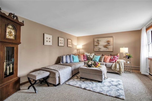 carpeted living area with baseboards and a baseboard heating unit