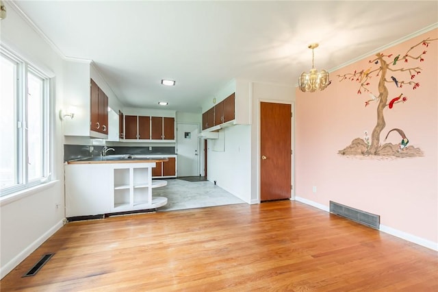 kitchen featuring a chandelier, visible vents, and a healthy amount of sunlight