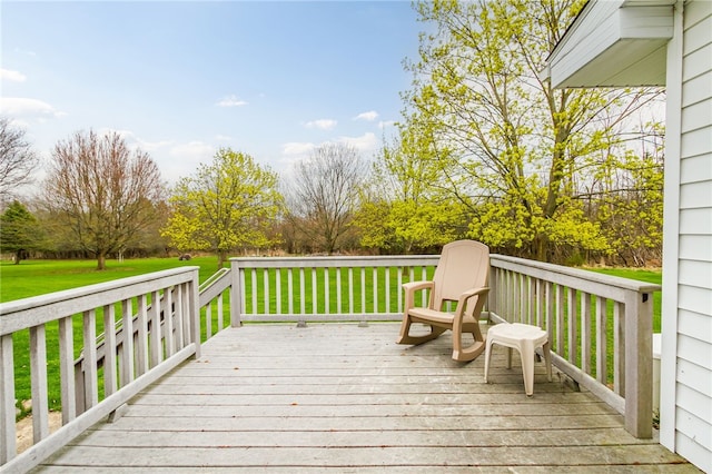 wooden deck featuring a lawn
