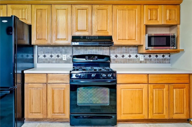 kitchen with light countertops, extractor fan, black appliances, and tasteful backsplash