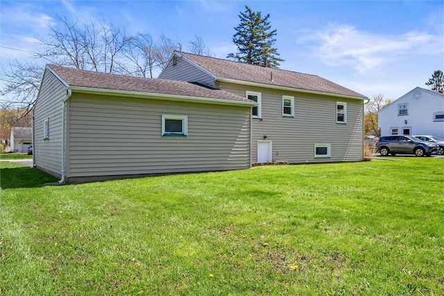 rear view of property with a yard