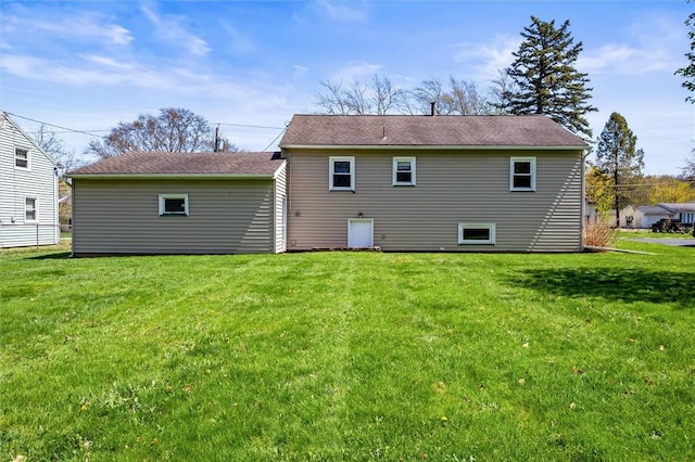 back of property featuring a lawn