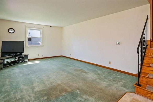 unfurnished living room featuring stairway, carpet floors, and baseboards