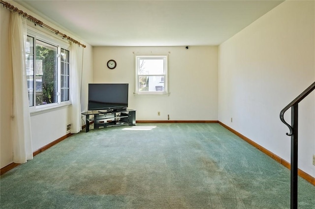 unfurnished living room with baseboards, carpet flooring, and visible vents