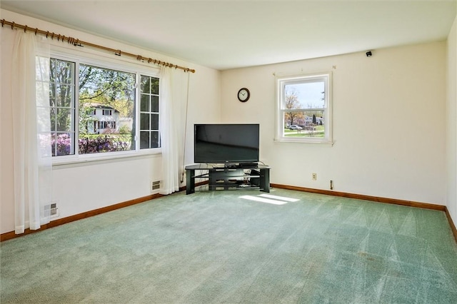 living room with carpet floors, baseboards, and visible vents