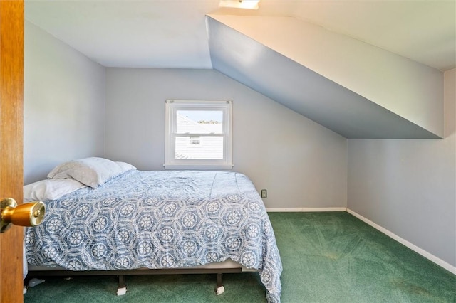 carpeted bedroom with baseboards and vaulted ceiling