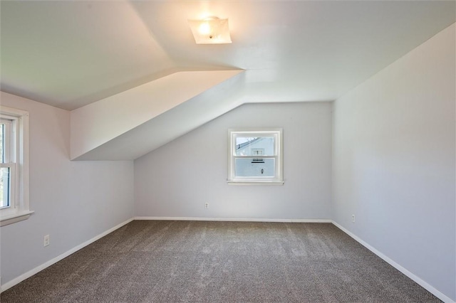 bonus room featuring carpet flooring, baseboards, and vaulted ceiling