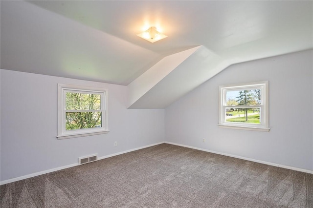 bonus room featuring visible vents, baseboards, carpet floors, and lofted ceiling