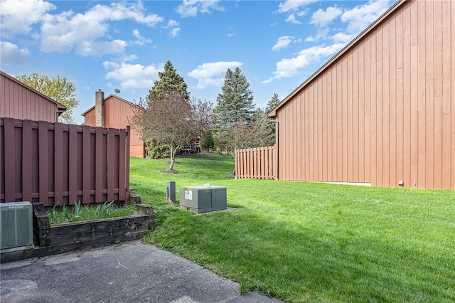 view of yard with fence and cooling unit