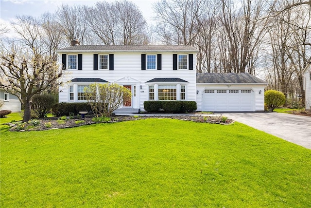 655 Finchingfield Ln, Webster, NY 14580 - view of front of property featuring concrete driveway, an attached garage, a chimney, and a front yard
