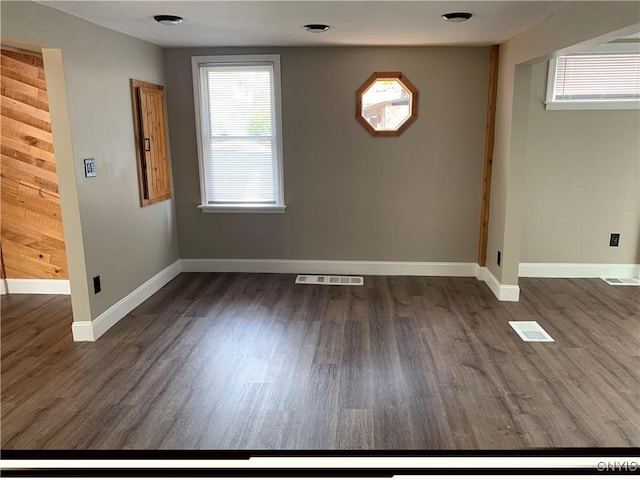unfurnished dining area featuring baseboards, wood finished floors, and visible vents