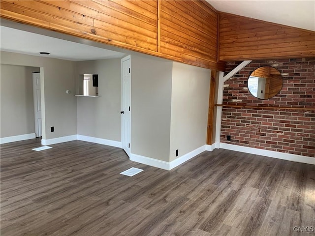 empty room featuring baseboards and dark wood-type flooring
