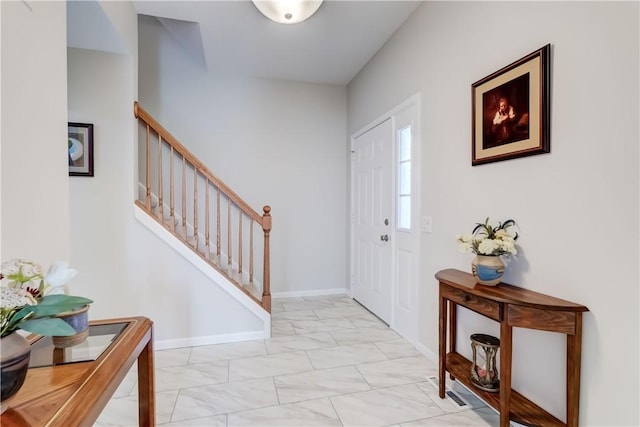 entryway featuring stairway, baseboards, and marble finish floor
