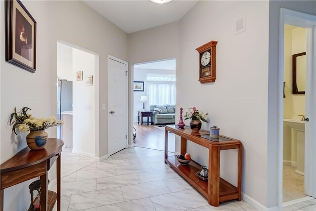 hall featuring marble finish floor