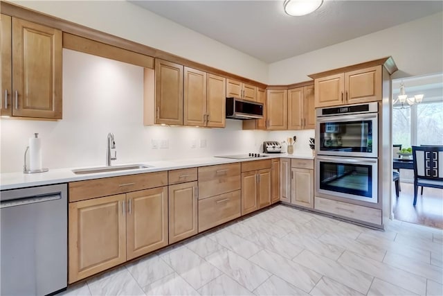 kitchen featuring a sink, light countertops, light brown cabinets, and stainless steel appliances