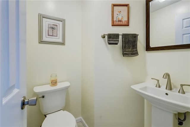 bathroom featuring toilet and a sink