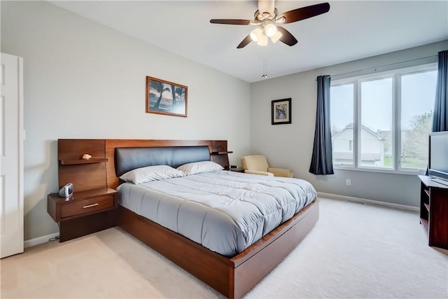 bedroom with a ceiling fan, baseboards, light colored carpet, and visible vents