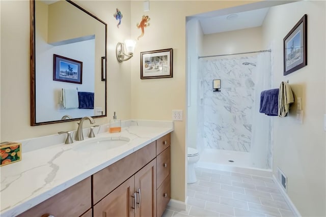 full bath featuring vanity, toilet, tile patterned floors, visible vents, and a stall shower