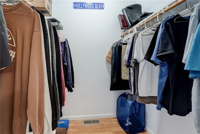 spacious closet featuring wood finished floors and visible vents