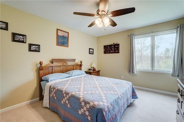 bedroom with baseboards, a ceiling fan, and light colored carpet