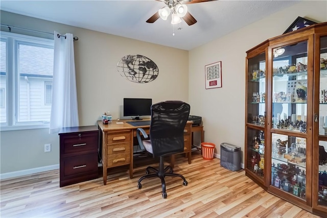 office area featuring a ceiling fan, baseboards, and light wood-style floors